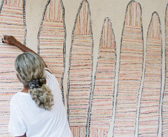 Regina Pilawuk Wilson works on her mural 