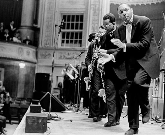 Black and white photograph of musicians performing on stage