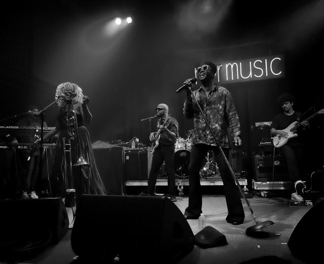 Black and white photograph of band playing on stage