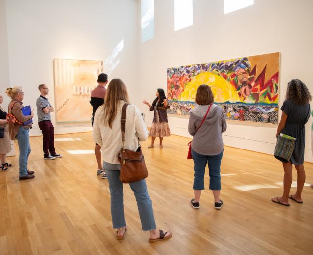 Educators observing a large painting, led by a Phillips educator 