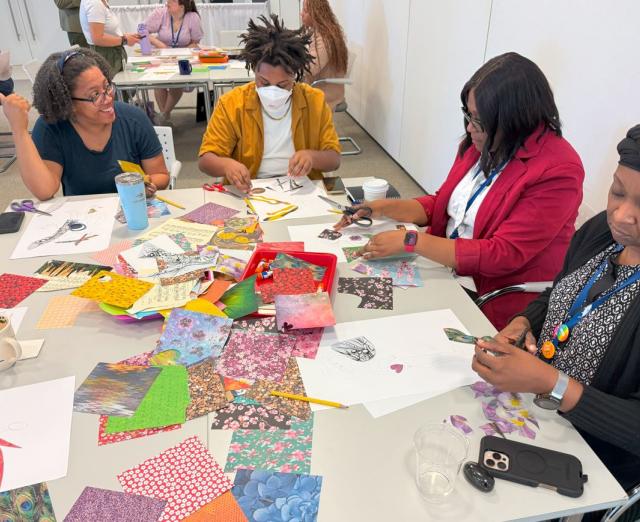 Four people sitting at a table making collages during Pew workshop