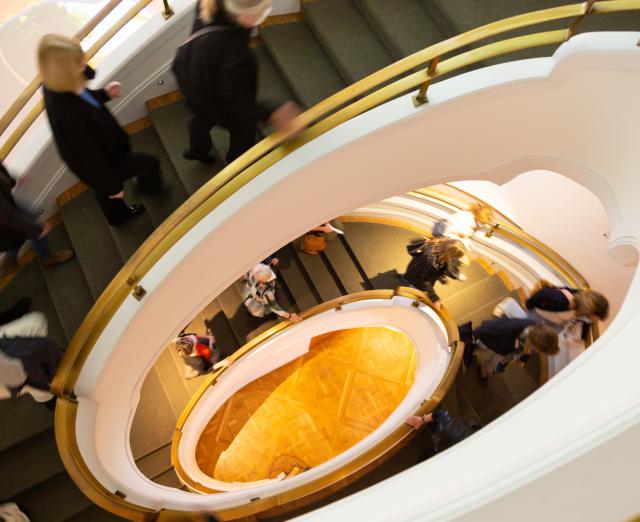 Overhead view of people walking up the Goh Annex spiral stairwell