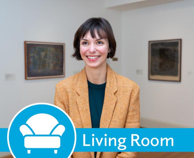 Photo of Clarisse Fava-Piz wearing a blazer standing in a gallery with art on the walls