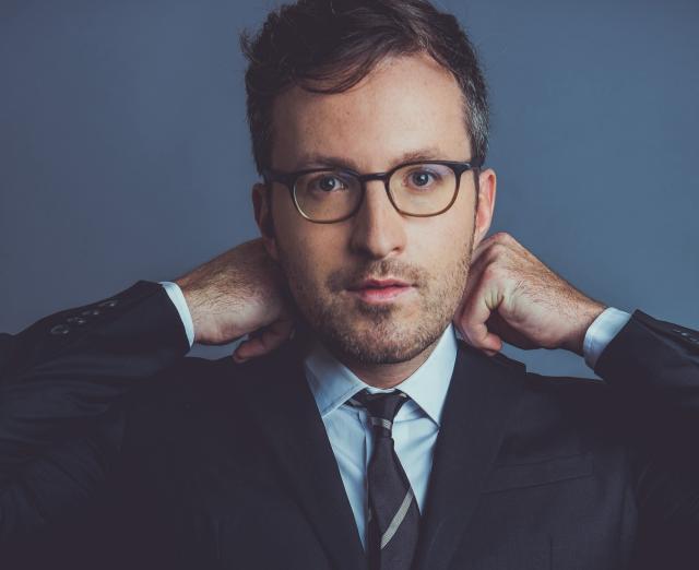 Photo of Conor Hanick wearing a suit