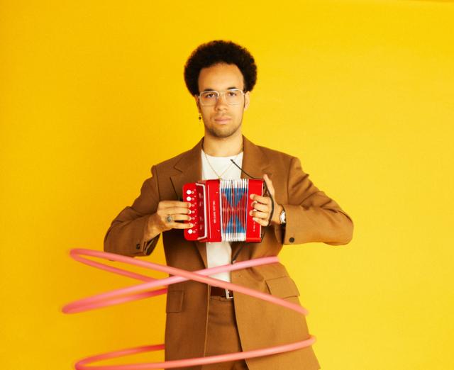 Theo Ould holding a small accordion
