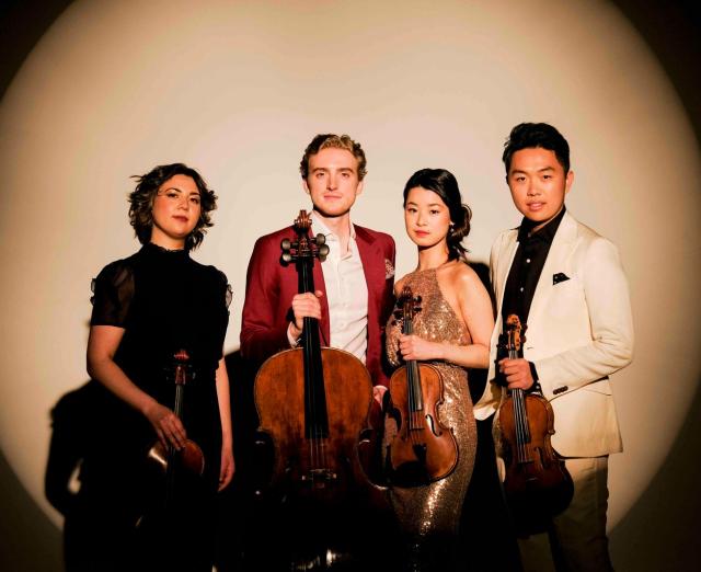 Viano Quartet standing in a spotlight