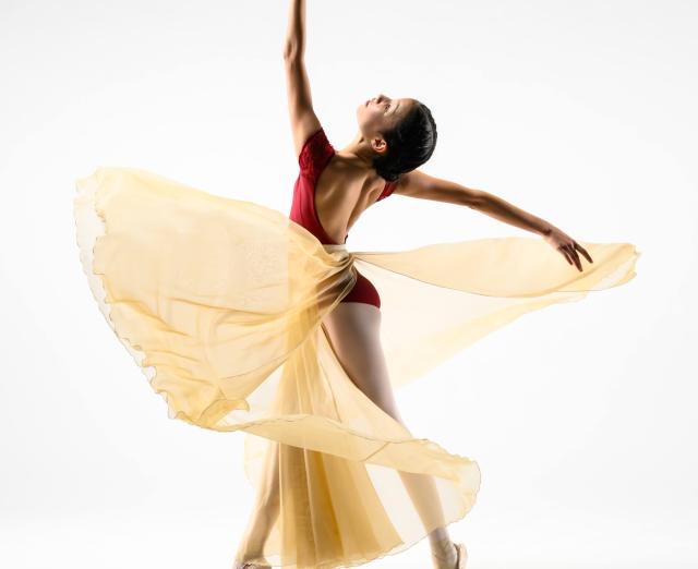 Ballet dancer posing on white background