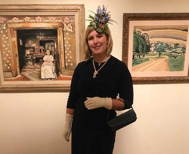 Photograph of a woman with a fancy had in the galleries