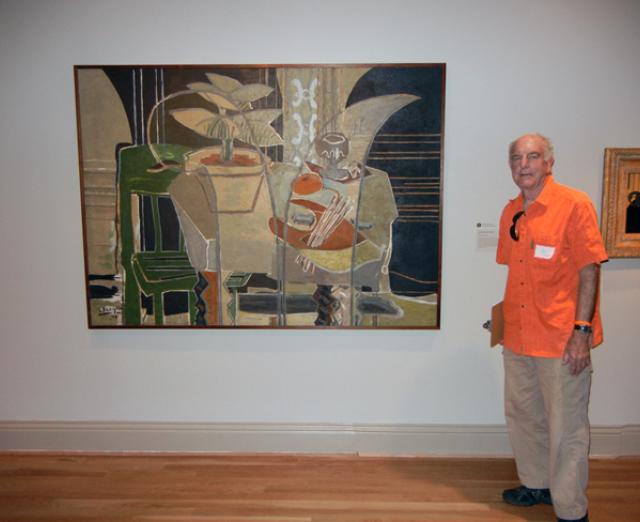 Exhibition Designer Val Lewton stands by one of his favorite paintings in the Braque exhibition. 