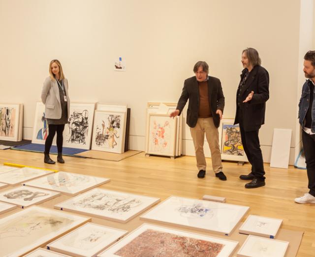 Finalizing layout plans. Left to right: Manager of Exhibitions Liza Strelka, contemporary artist George Condo, Exhibition Curator Klaus Ottmann, Condo studio assistant Benjamin Provo