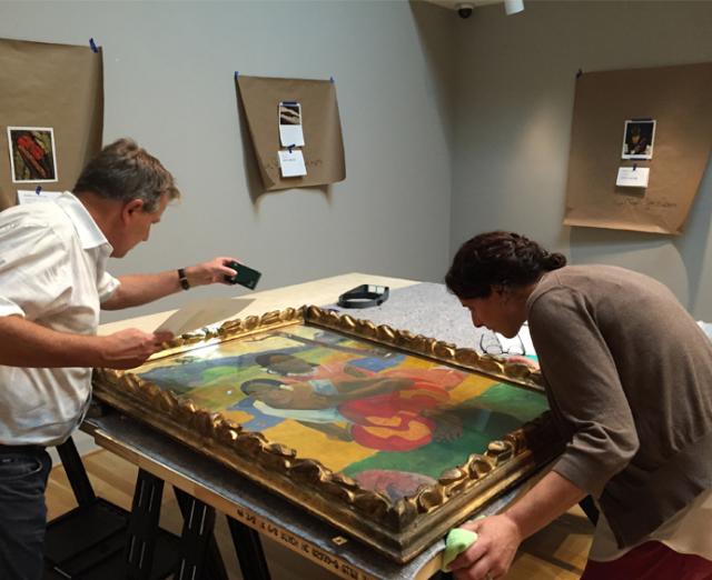 Paul Gauguin's NAFEA faaipoipo (When Will You Marry?) gets an inspection before hanging in in the Phillips's galleries.