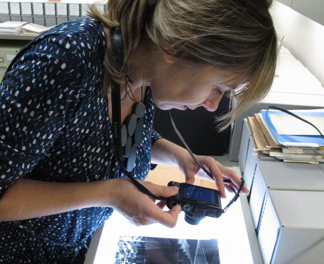 Vesna Pavlovic examining photographs in the Phillips archives