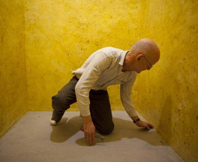 Wolfgang Laib installing the wax room at The Phillips Collection