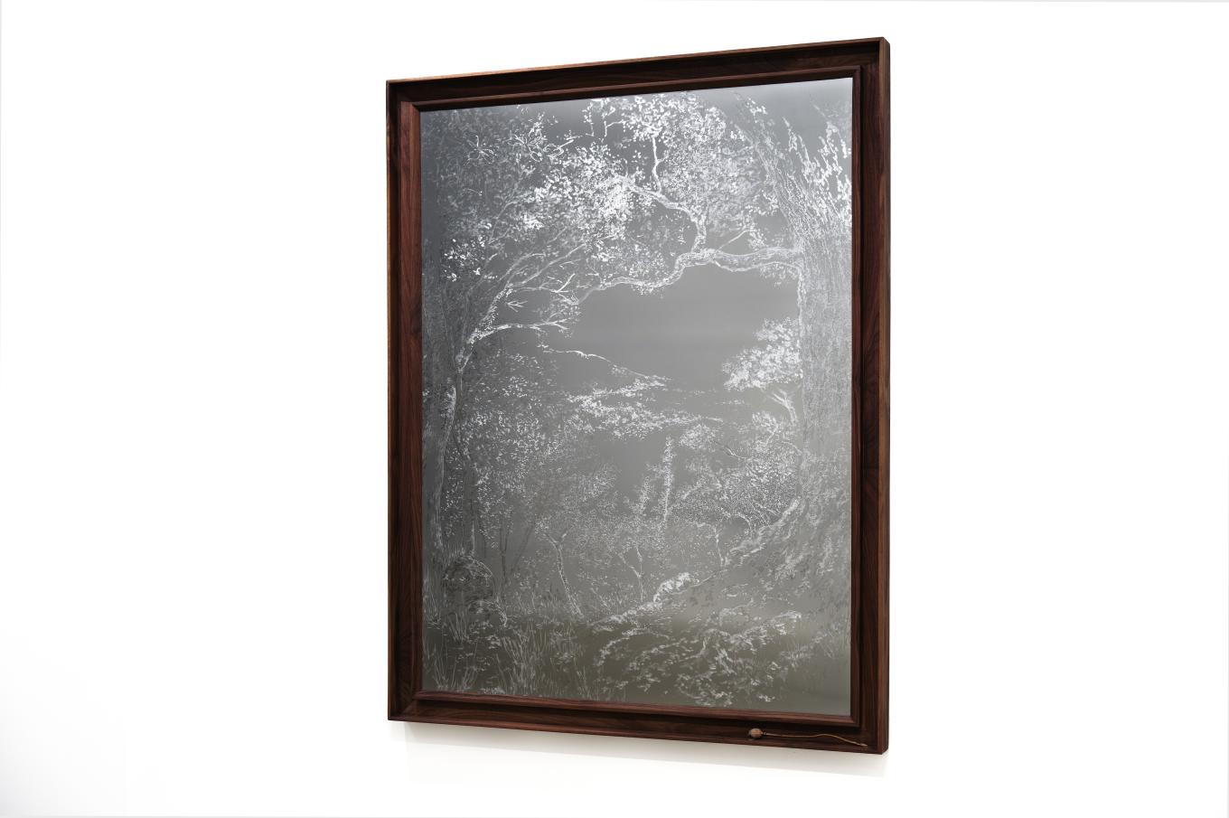 Engraving on aluminum in a brown wooden frame