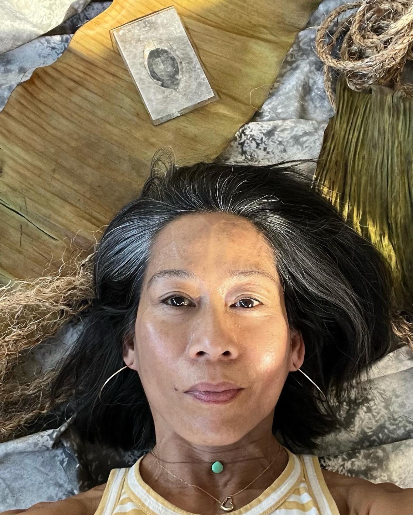 Photograph of Tina Villadolid laying on the ground