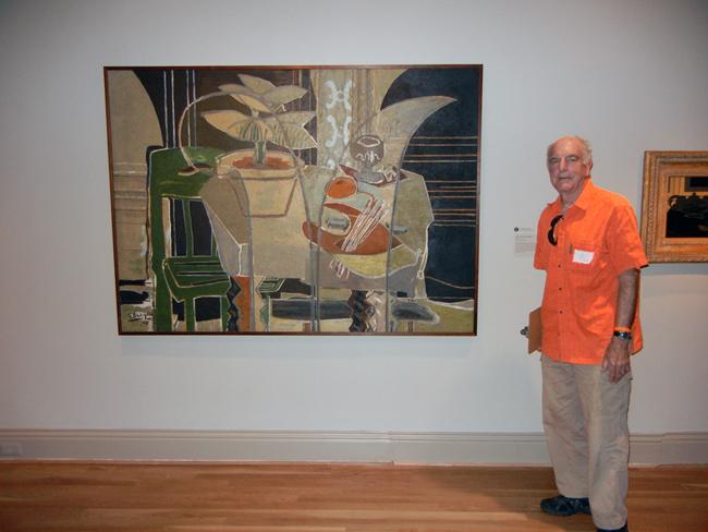 Exhibition Designer Val Lewton stands by one of his favorite paintings in the Braque exhibition.