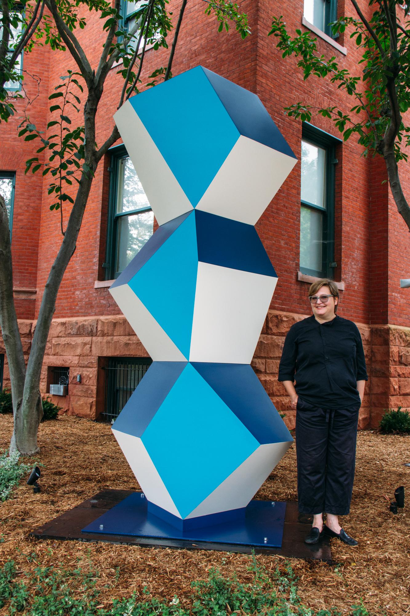 Angela Bulloch with her sculpture. Heavy Metal Stack: Fat Cyan Three, 2018