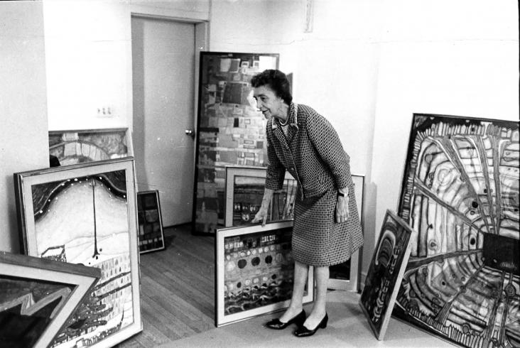 Marjorie Phillips stands with works of art