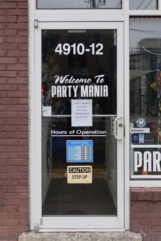 Photograph of a store with a closed sign