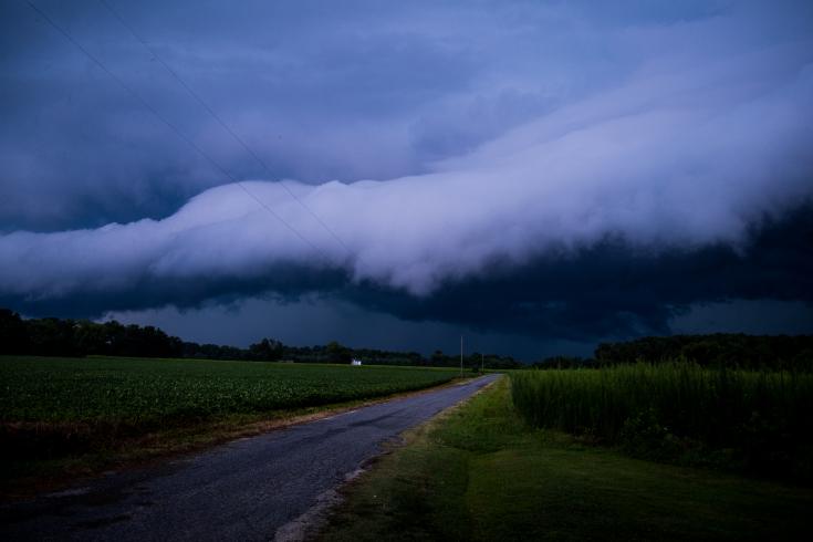 Photograph of oncoming storm over open road