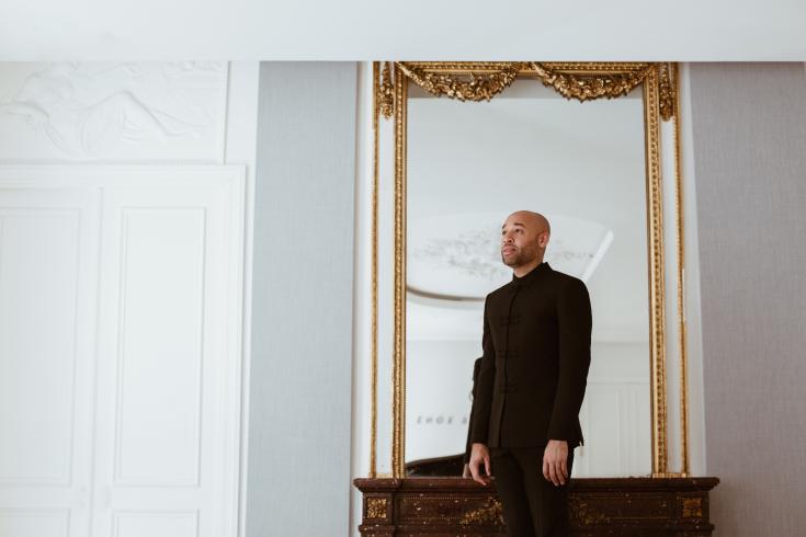 Pianist Aaron Diehl standing in front of a mirror