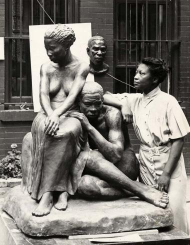 Photograph of sculptor August Savage with her sculpture