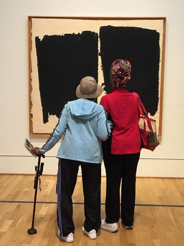 Two woman viewing artwork