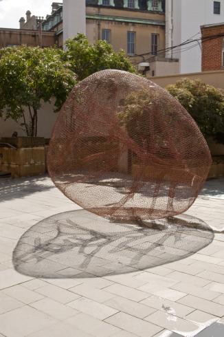 Photograph of a wire spherical sculpture in the Phillips Collection Hunter Courtyard
