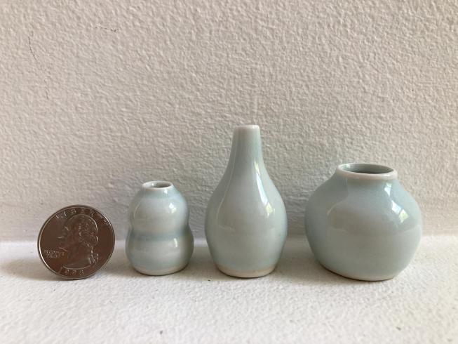 Three very small porcelain vases.