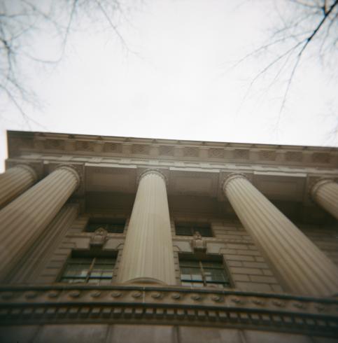Image of columned building photographed from an upward view  