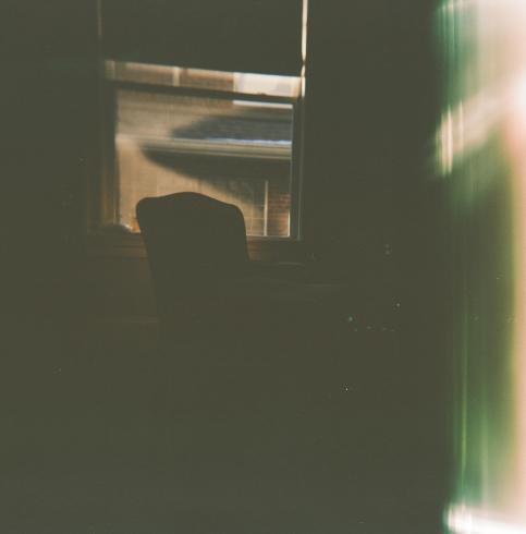 Silhouette of a chair against a window 