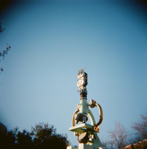 Image of sculpture of a microscope against a blue sky 