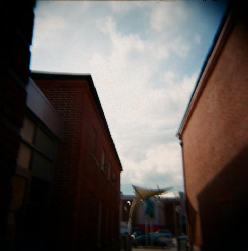 Image of brick red buildings photographed from an upward perspective 