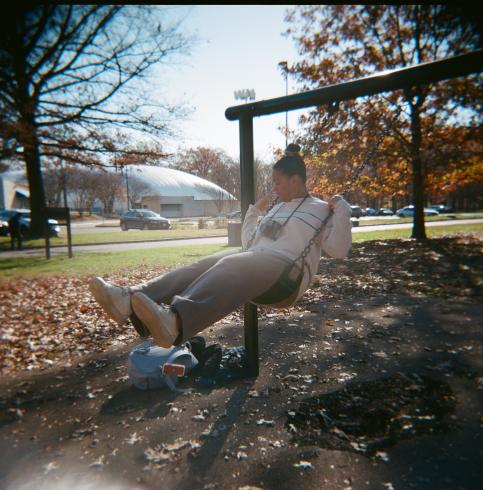 Image of a person swinging on swing on a fall day 