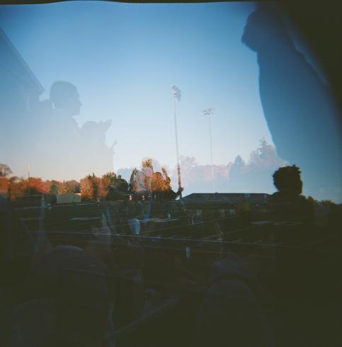 Double exposed images of people at a footbal game 