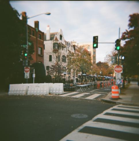 Image of a crosswalk with two traffic lights that are green