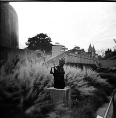 Black and white image of a sculpture in garden