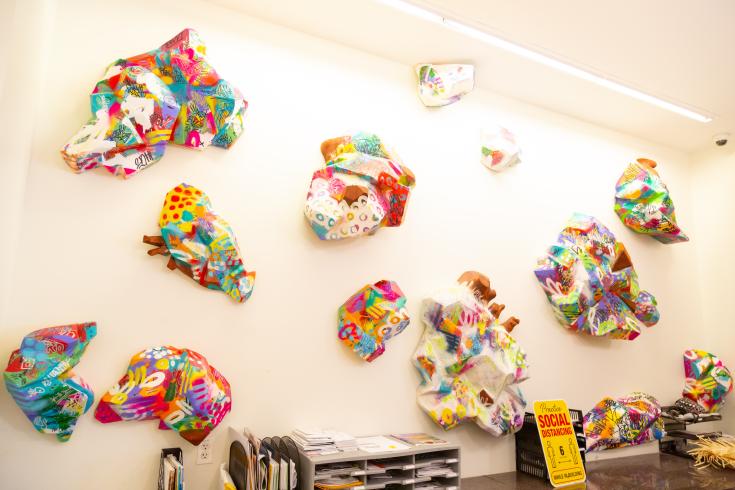 Photograph of Wesley Clark installation in THEARC West lobby with colorful geometric sculptural shapes on white wall