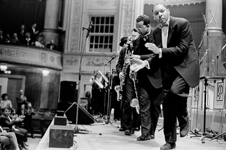 Black and white photograph of musicians performing on stage