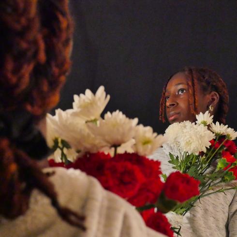 Photograph of student with their flower bouquet 