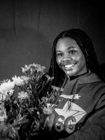 Photograph of student with their flower bouquet 