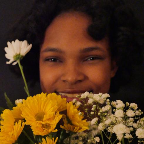 Photograph of student with their flower bouquet 