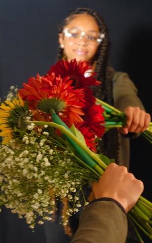 Photograph of student with their flower bouquet 