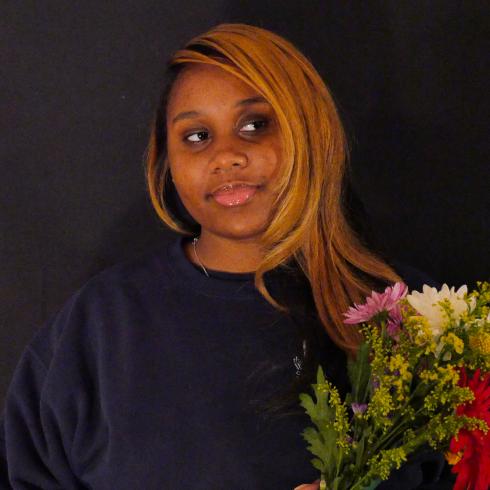 Photograph of student with their flower bouquet 