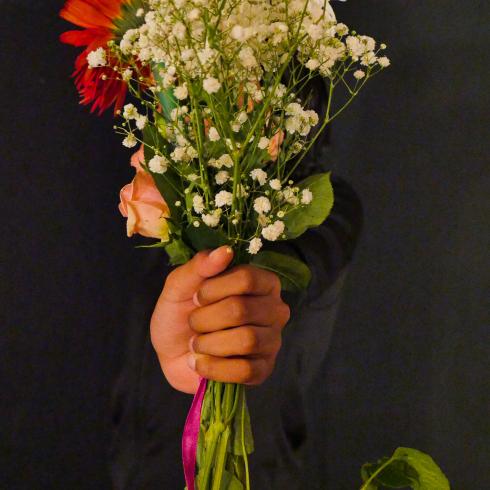 Photograph of student with their flower bouquet 