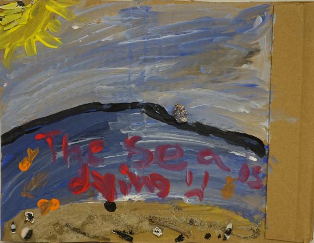 An ocean scene with the words, "The sea is dying =(" painted in red.