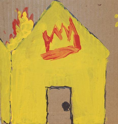 A yellow house on fire.