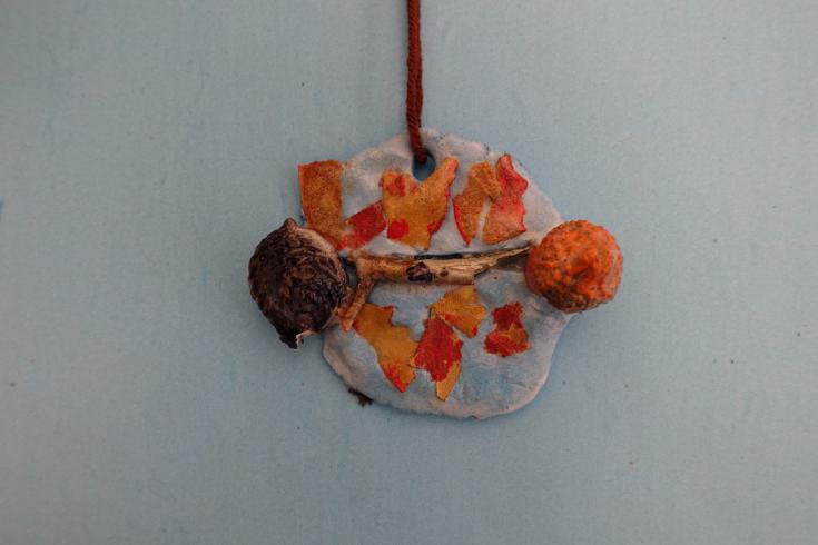 Clay mobile with orange leaves.