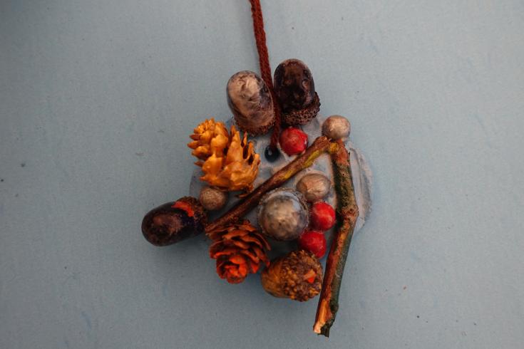 Clay mobile with painted acorns and holly.