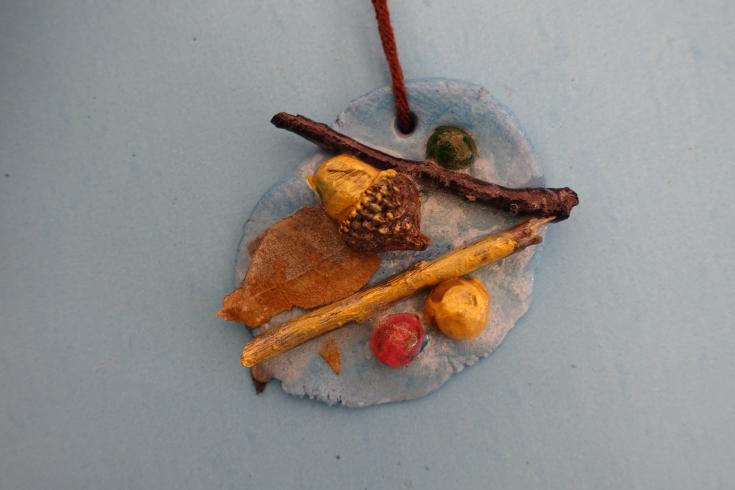 Clay mobile with painted sticks and holly.